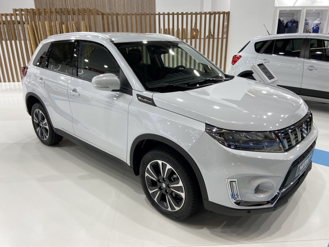 Front and side view of white compact SUV with LED headlights and alloy wheels