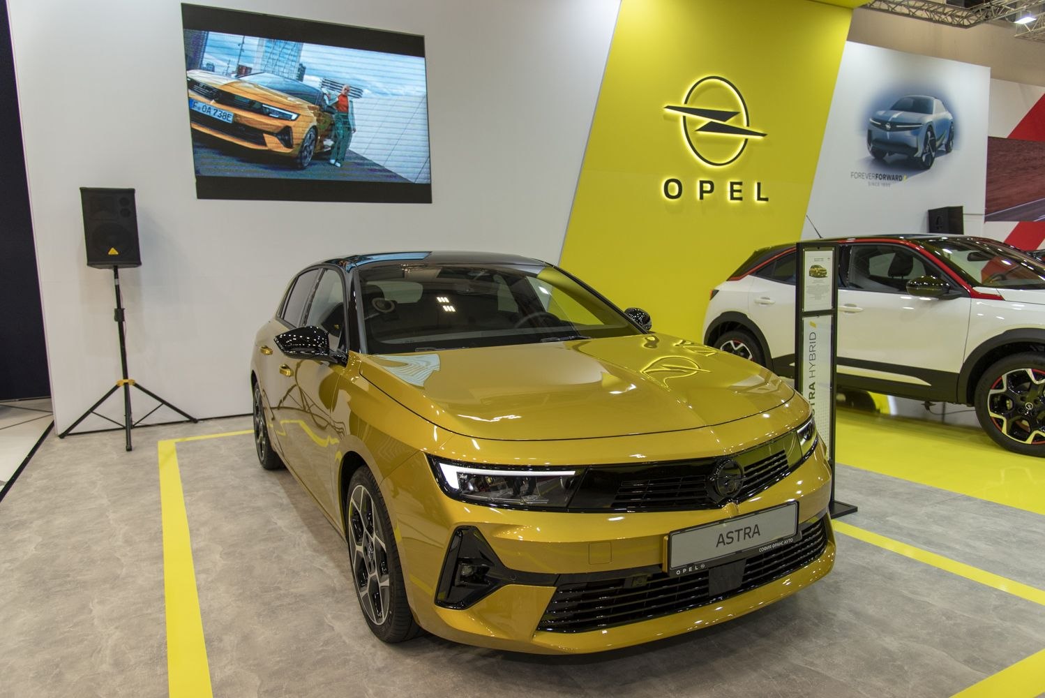 Front view of a yellow vehicle with sleek LED headlights and glossy finish