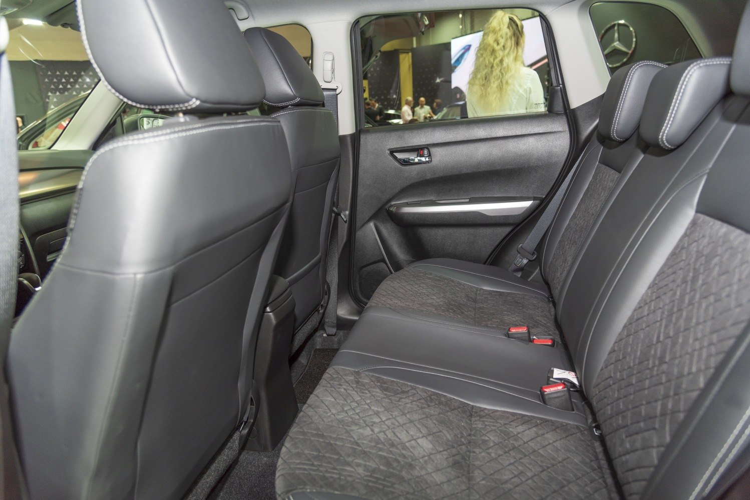 Spacious rear seating with black quilted upholstery and headrests.