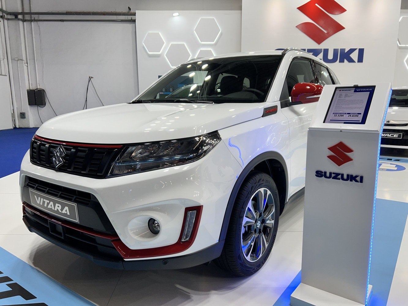 Front grille with red accents and sleek headlights of SUV
