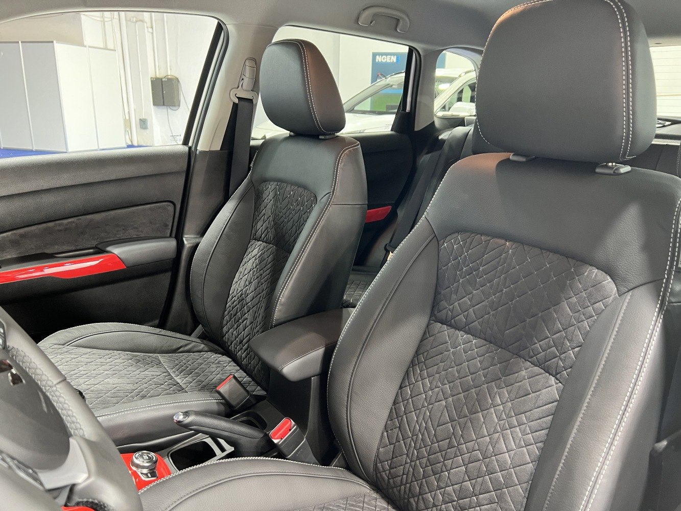 Front seats with quilted upholstery and red trim details