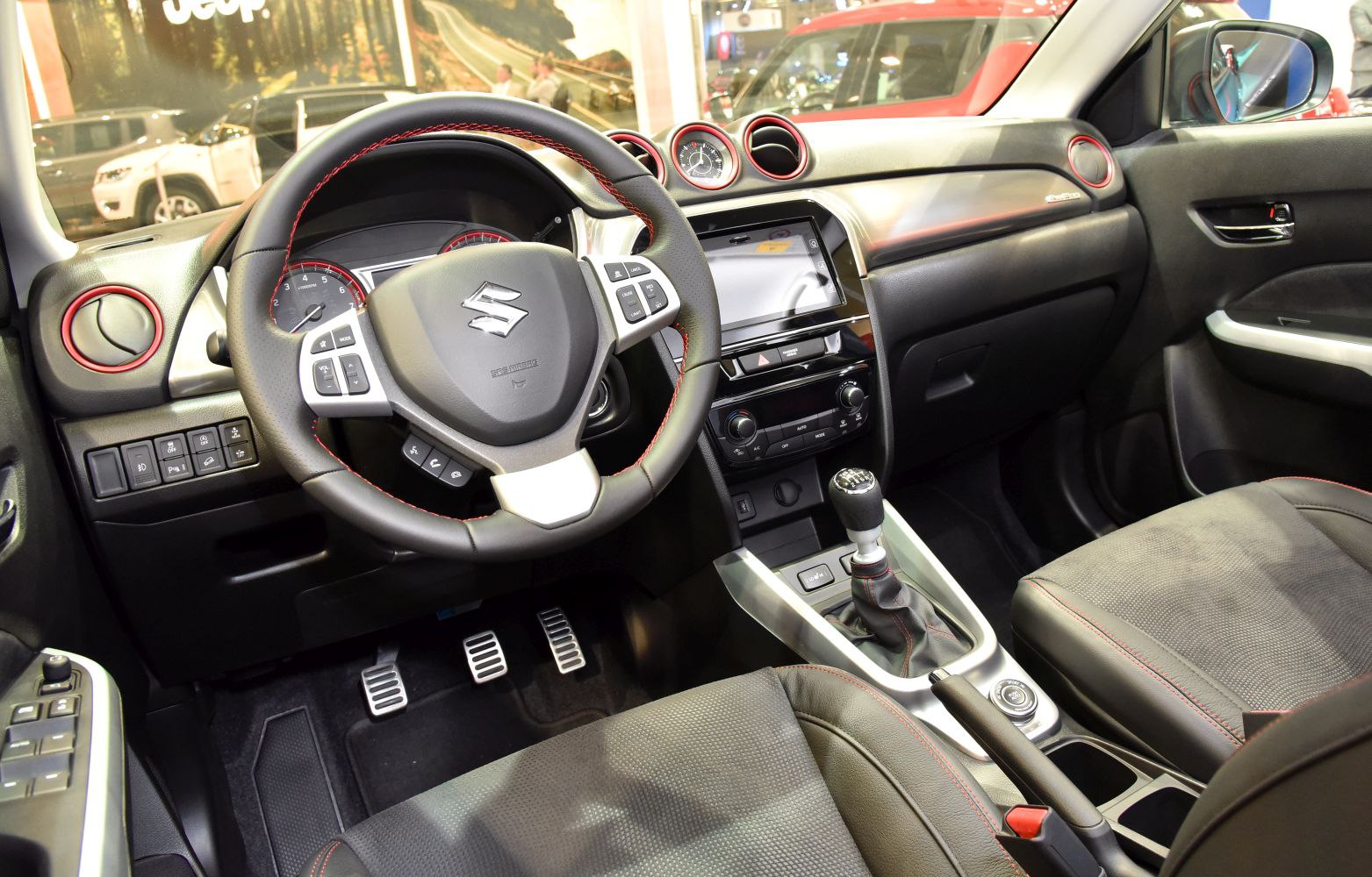 Sporty steering wheel, manual gear shift, and modern dashboard interior