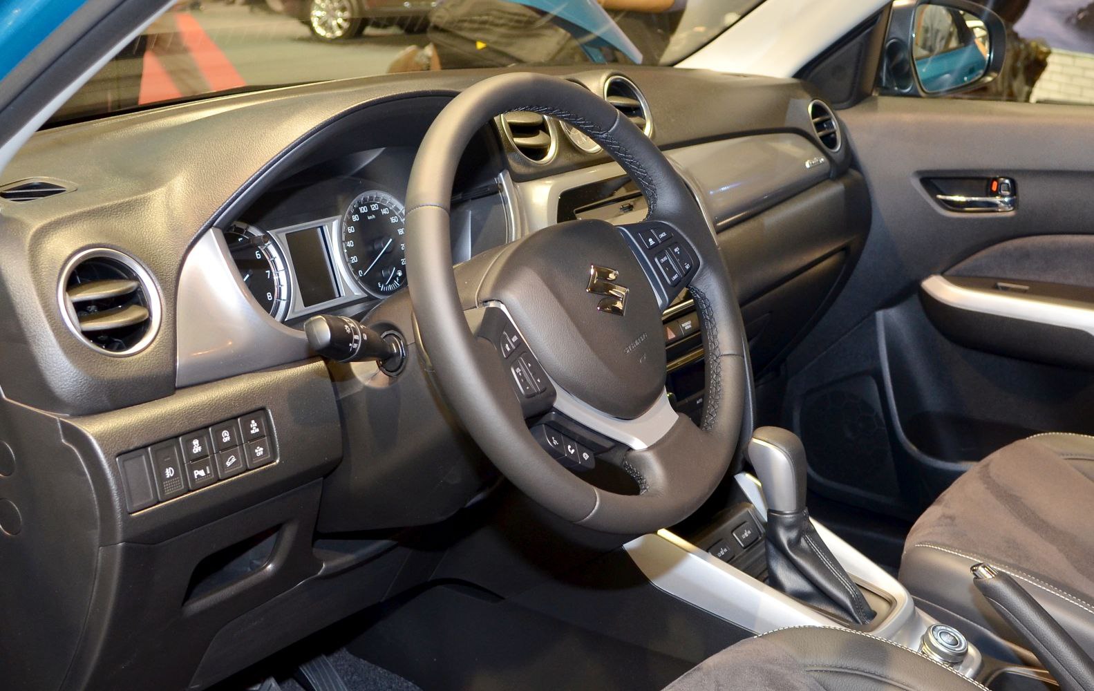 Steering wheel and dashboard with gear shift inside a vehicle