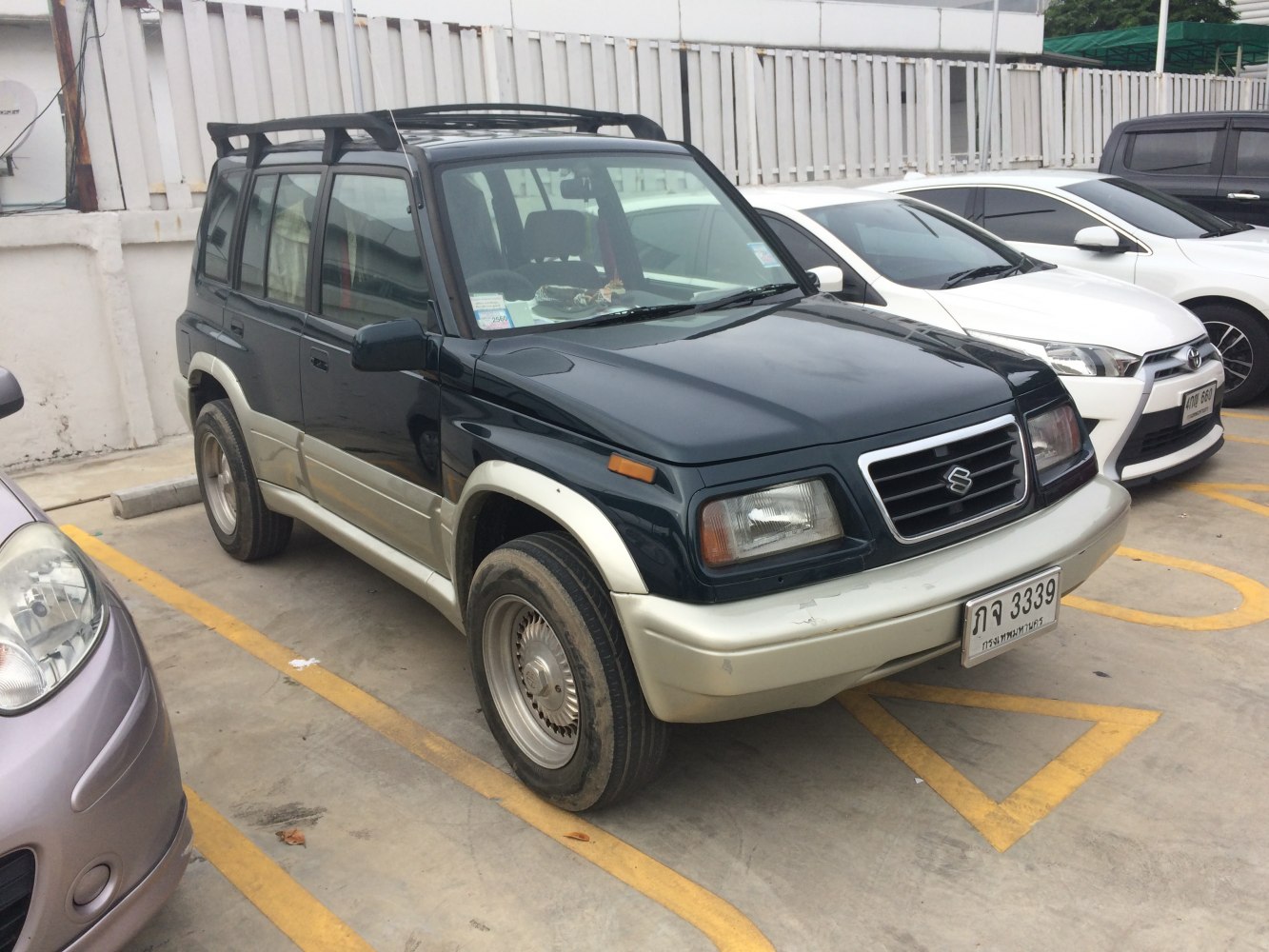 Boxy vintage SUV with two-tone paint and roof rack