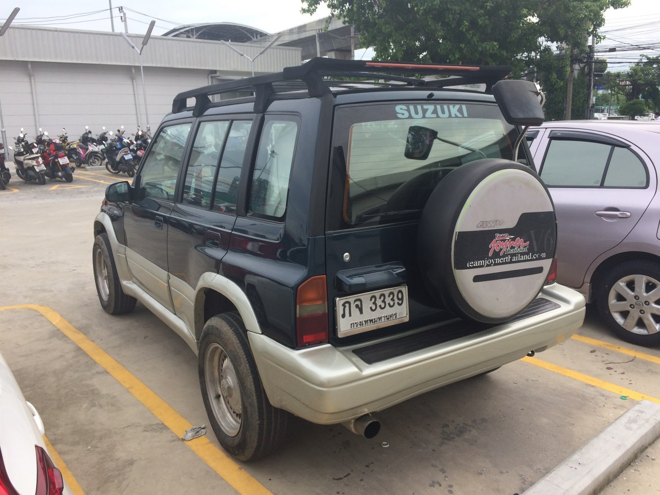 Rear view of SUV with spare wheel and roof rack