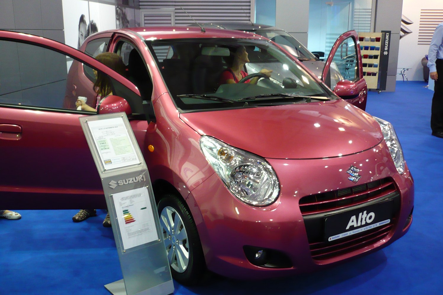 Compact small hatchback with open front doors shown from front perspective