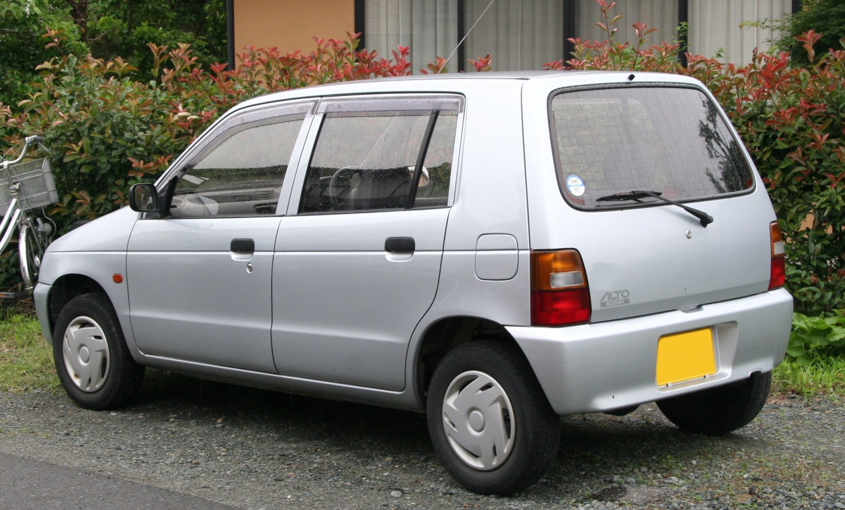 Side and rear profile of a compact small hatchback car with four doors and simple design