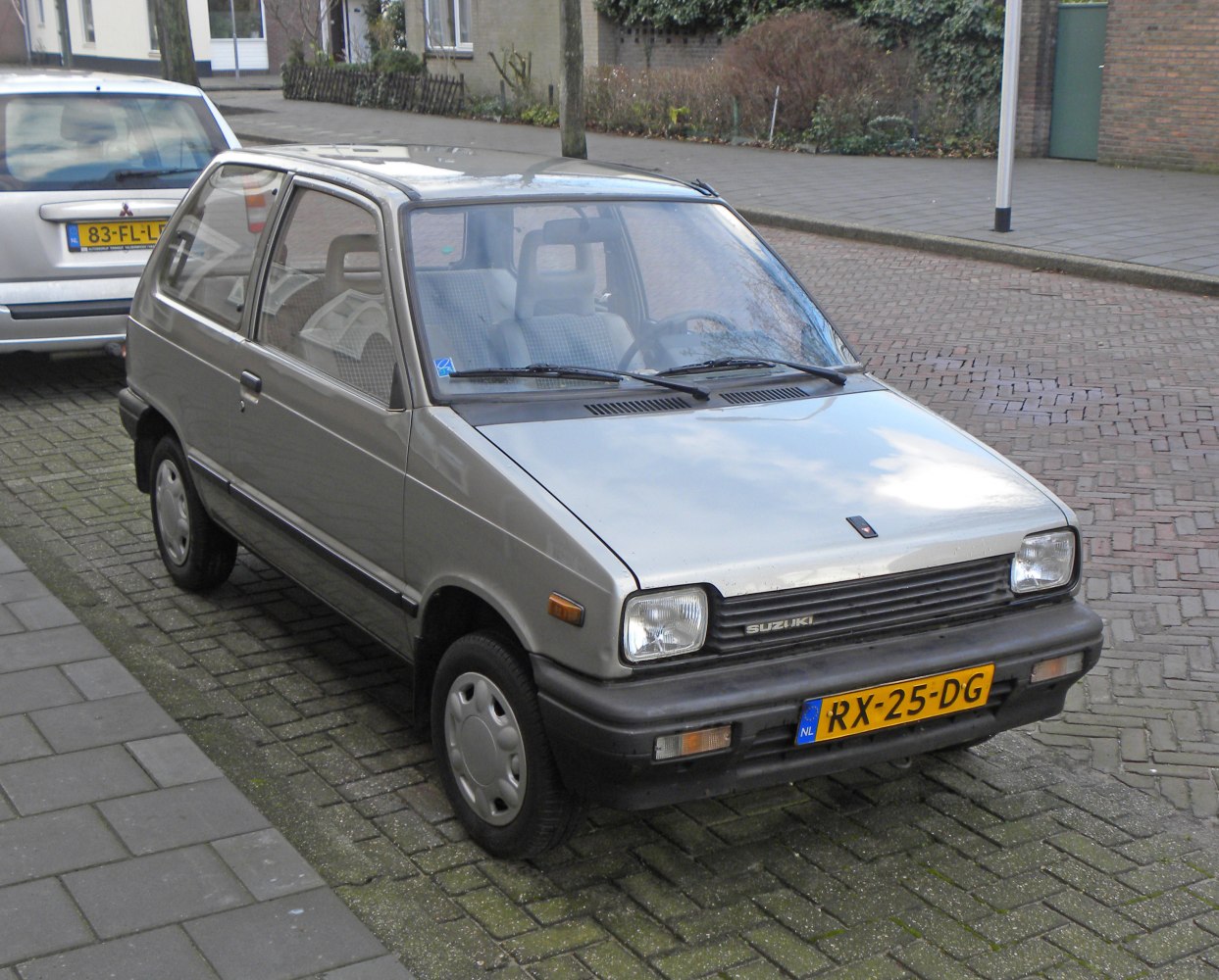 Front and side view of a compact 1980s small hatchback with rectangular headlights