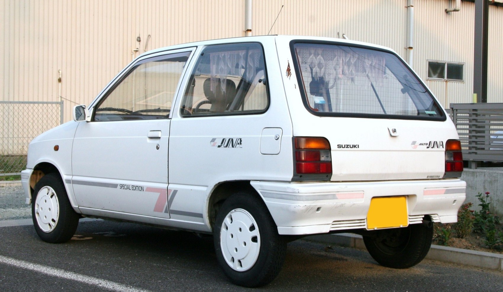 Compact hatchback rear side with white body and classic small car details