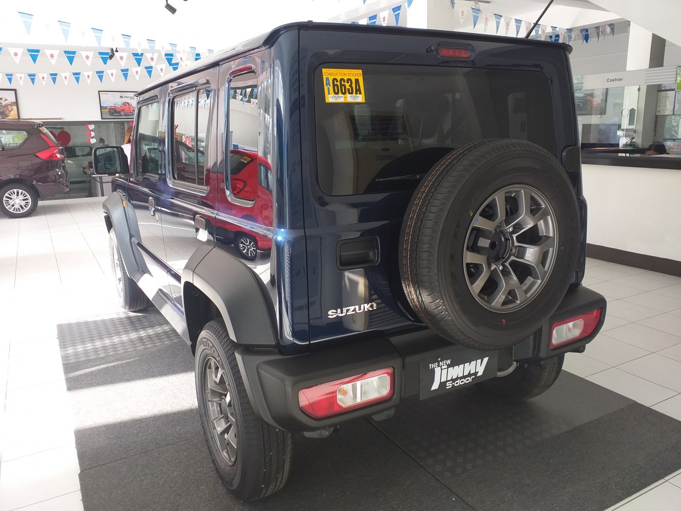 Rear view of 5-door SUV with spare tire on tailgate and black wheel arches