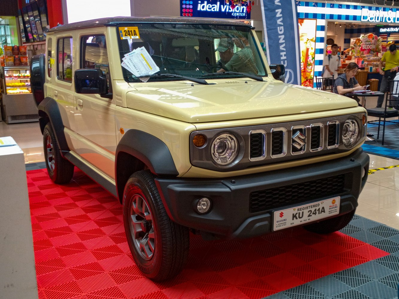 Front and side view with round headlights and rugged grille