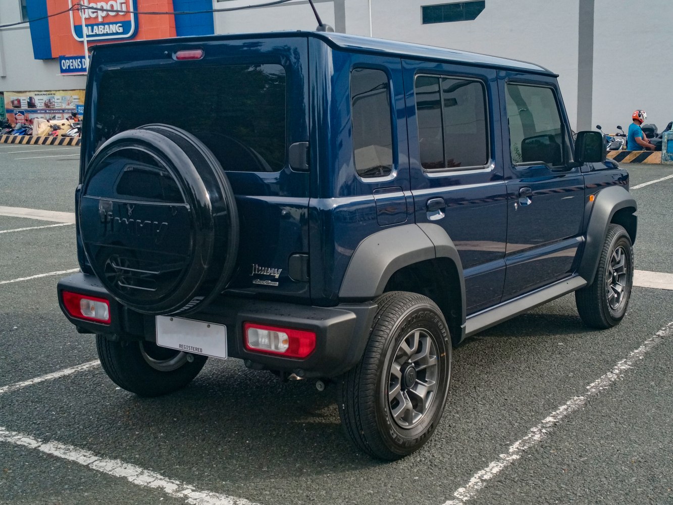 Rear and side view of 5-door SUV with spare tire on the back
