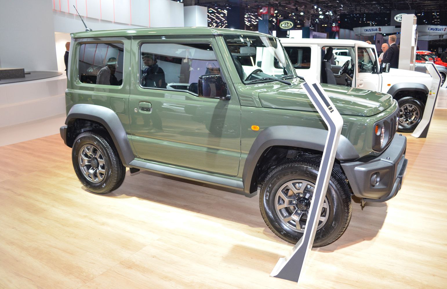 Compact green off-road SUV with boxy shape and flared arches