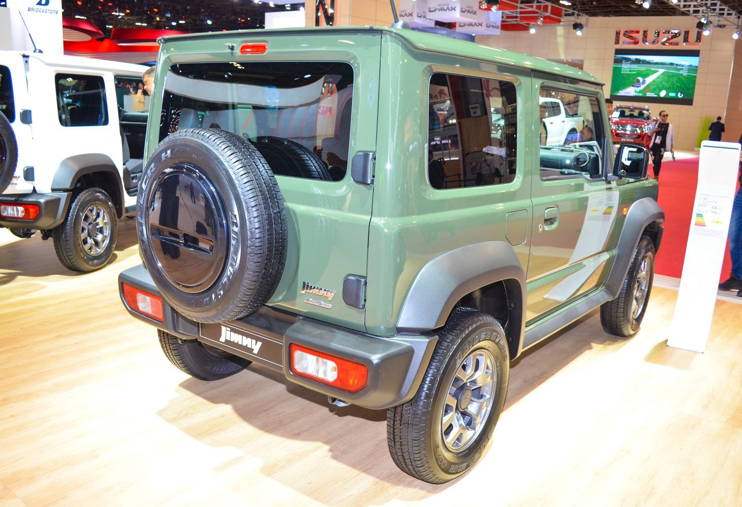 Rear view showing spare tire mount and boxy, compact 3-door SUV design