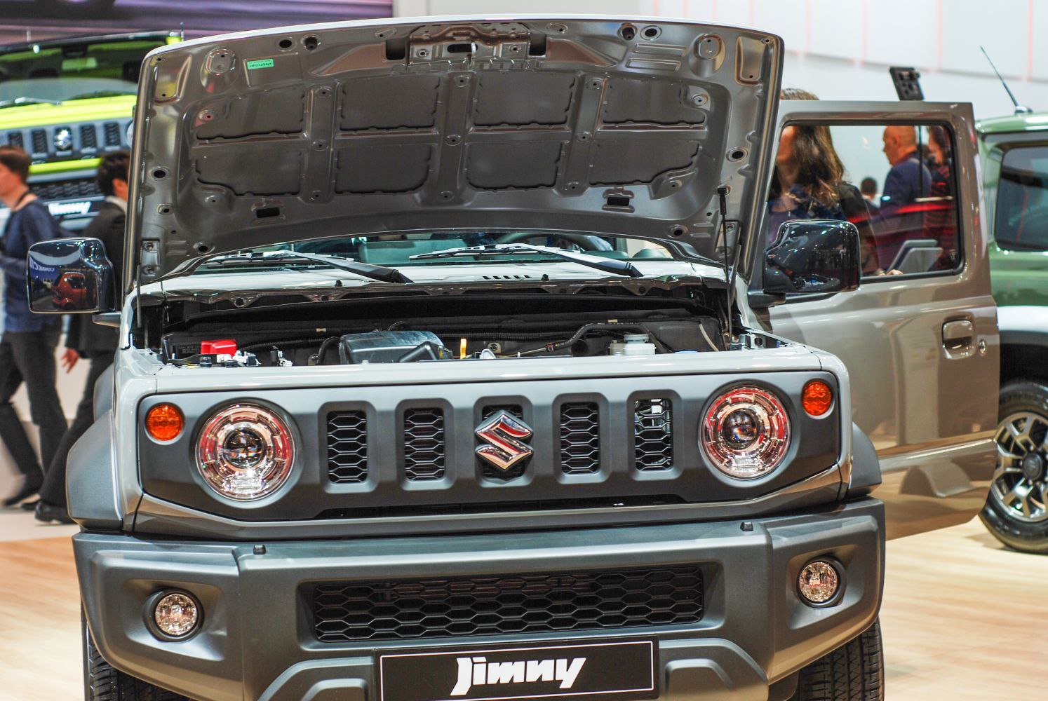 Open hood and front grille of small 3-door SUV