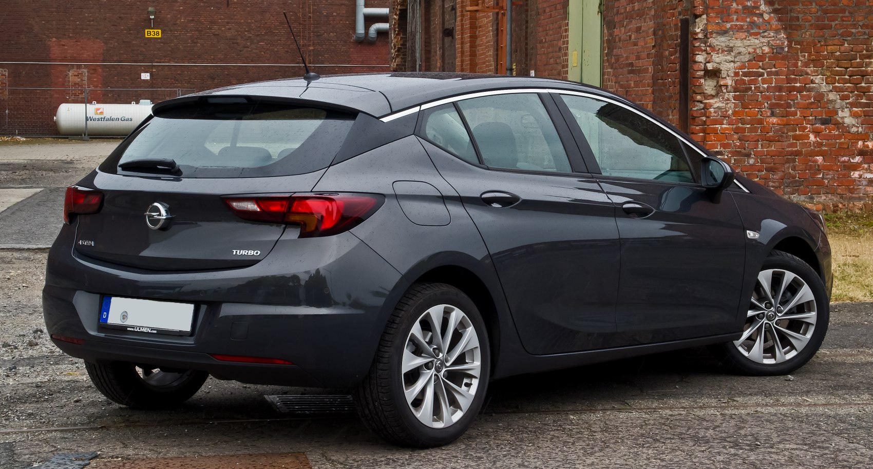 Rear side view of a grey compact hatchback with turbo badge and alloy wheels