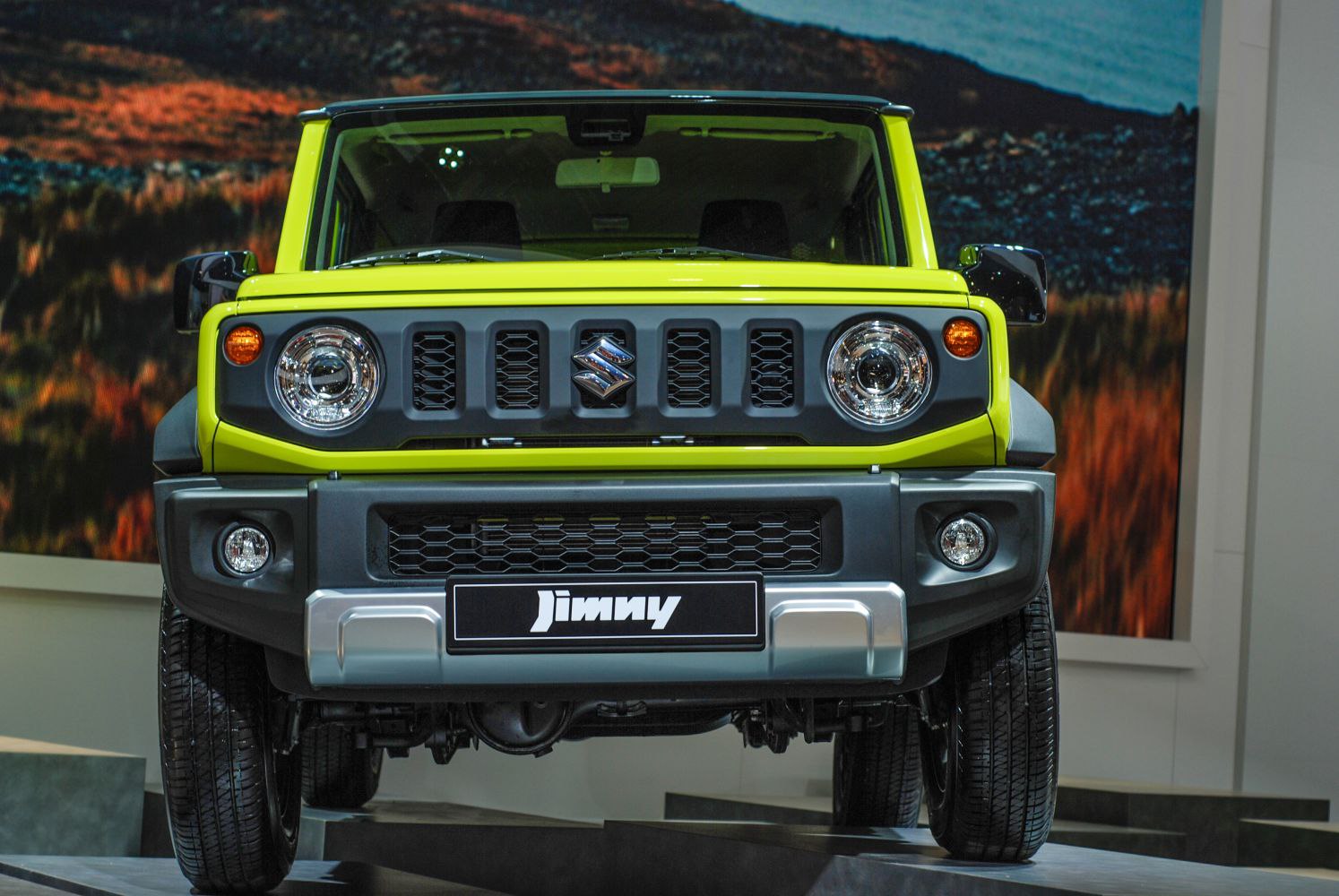 Front view with round headlights and multi-slot grille