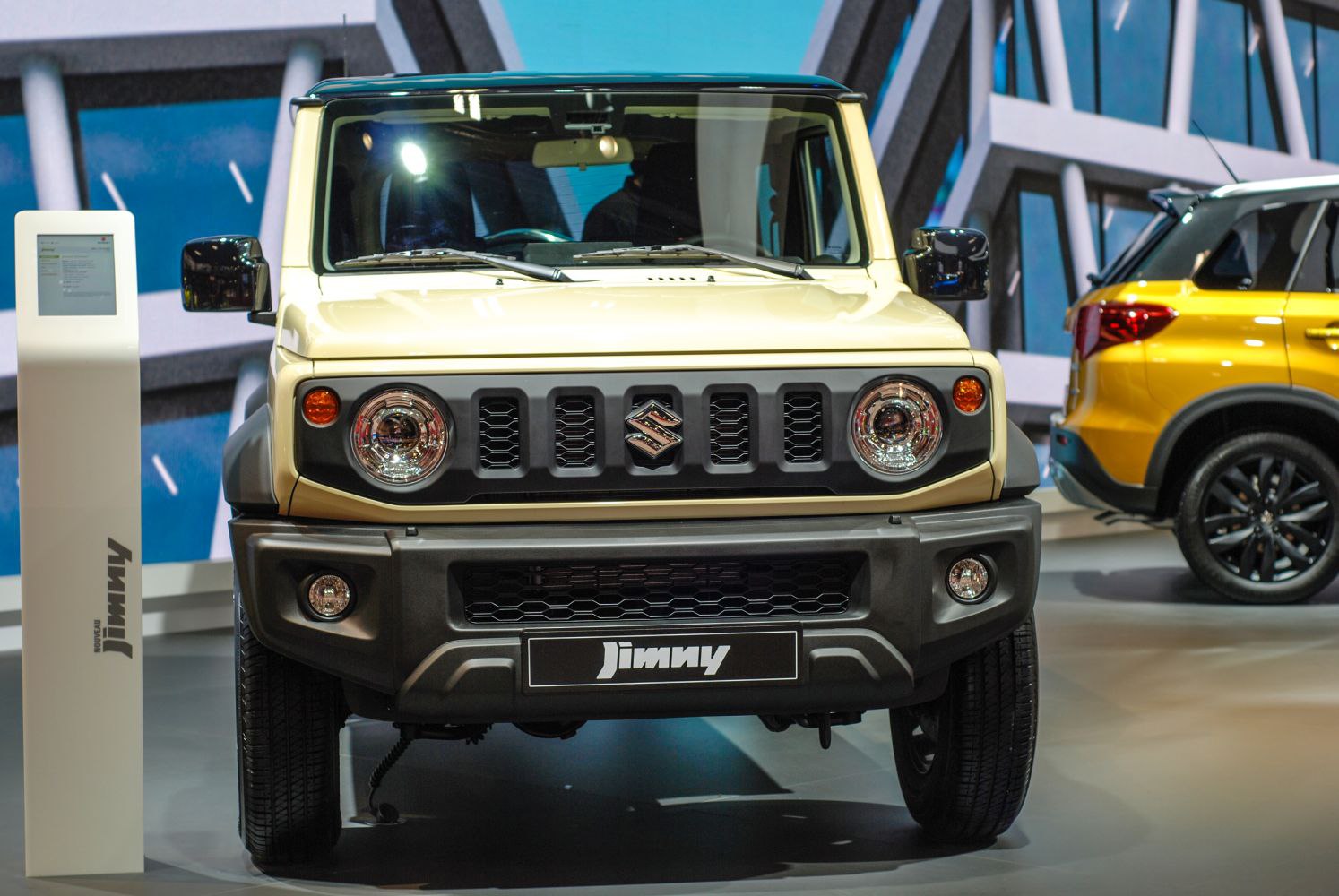 Front view of compact SUV with round headlights and grille