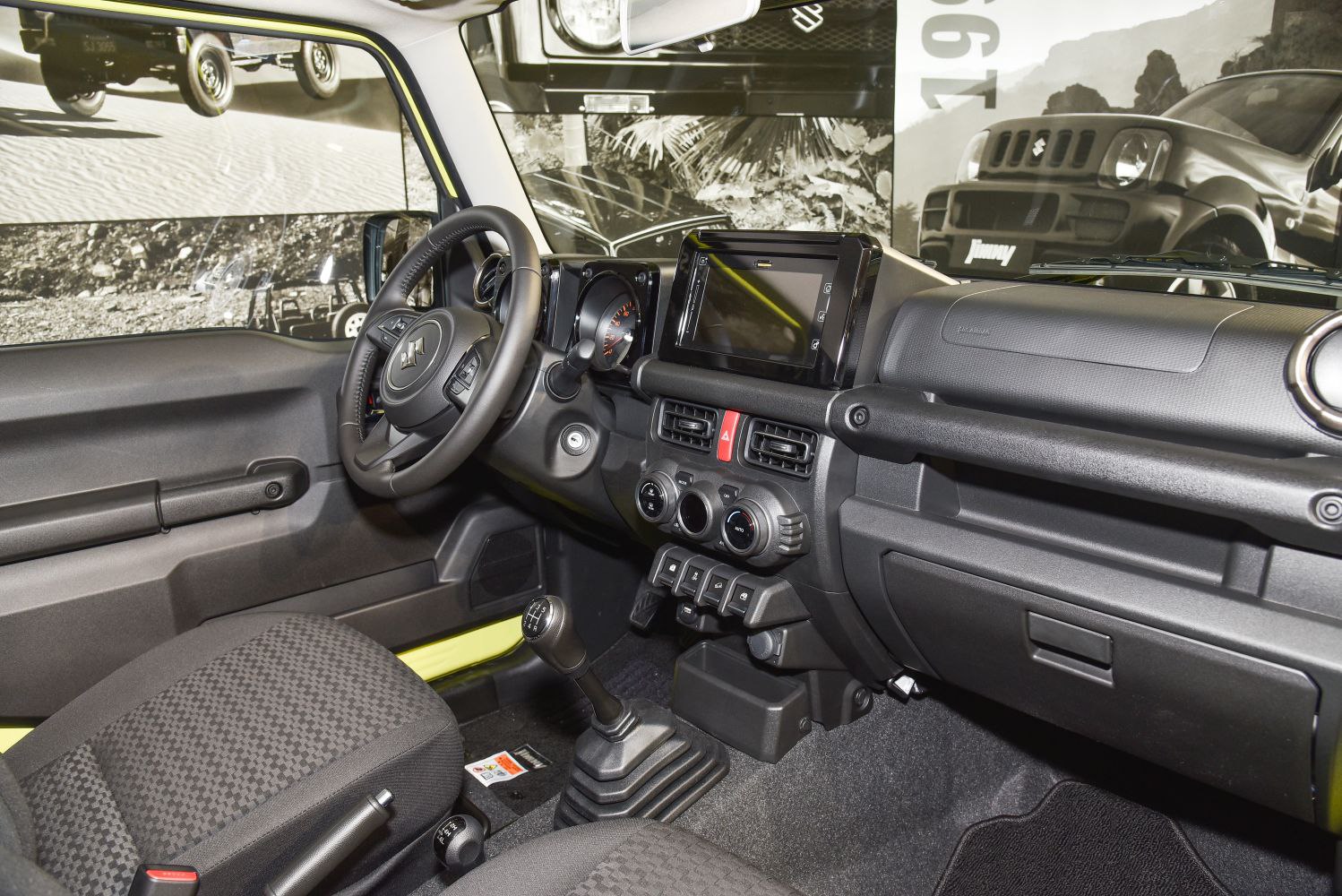 Interior dashboard with manual gear shift and modern controls.