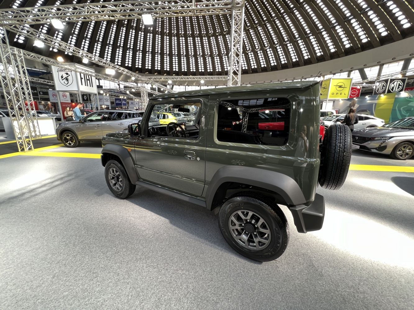 Compact 3-door off-road SUV with rear mounted spare wheel indoors