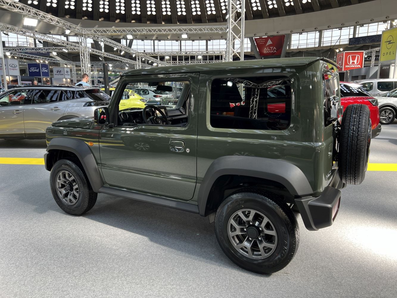 Side view of rugged compact SUV with rear spare tire and boxy design