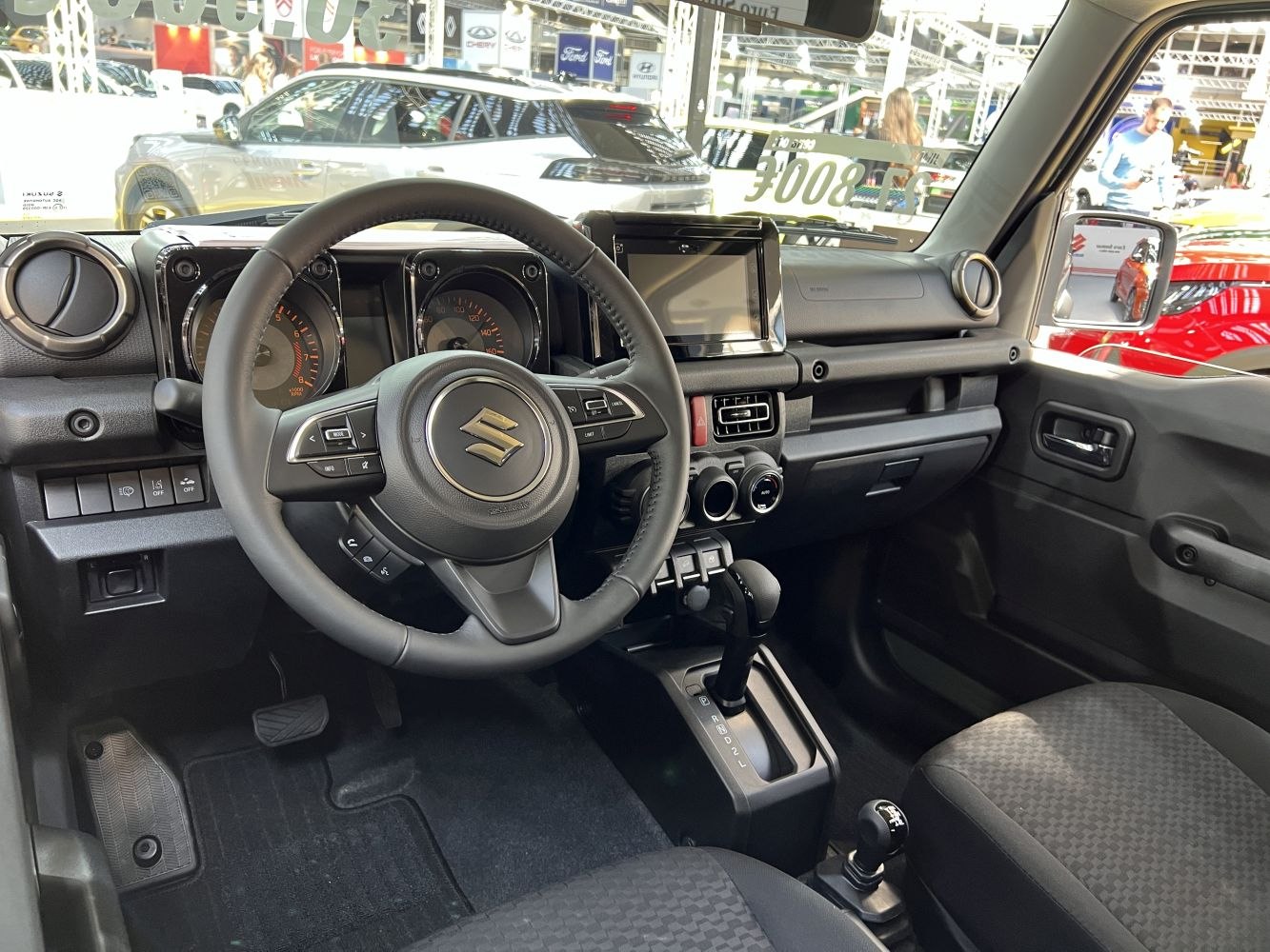 Interior of compact SUV with dashboard, steering wheel, and gear controls