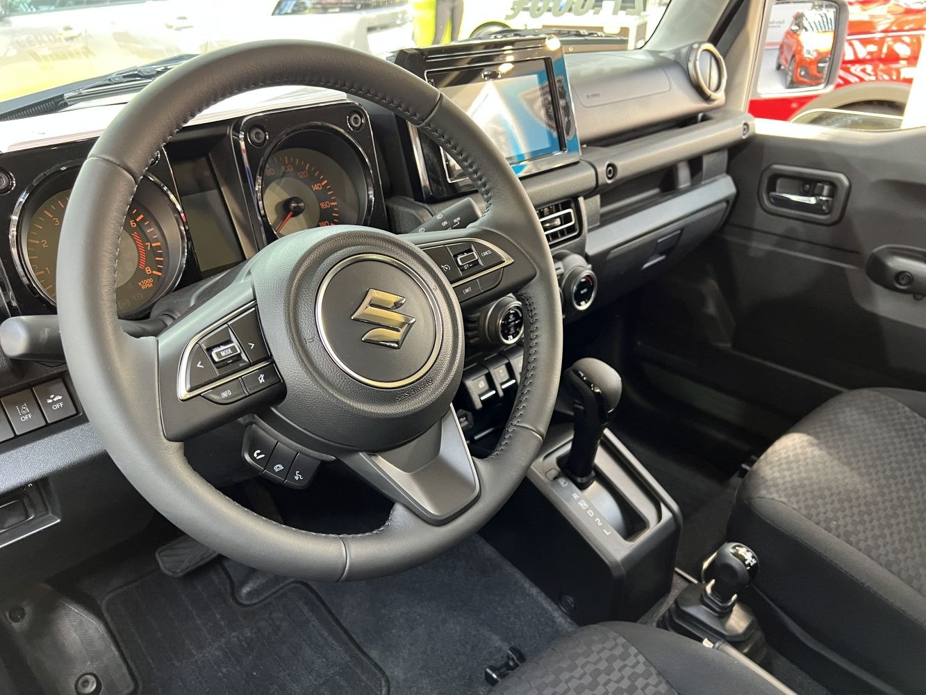 Steering wheel controls, instrument cluster, and center console layout