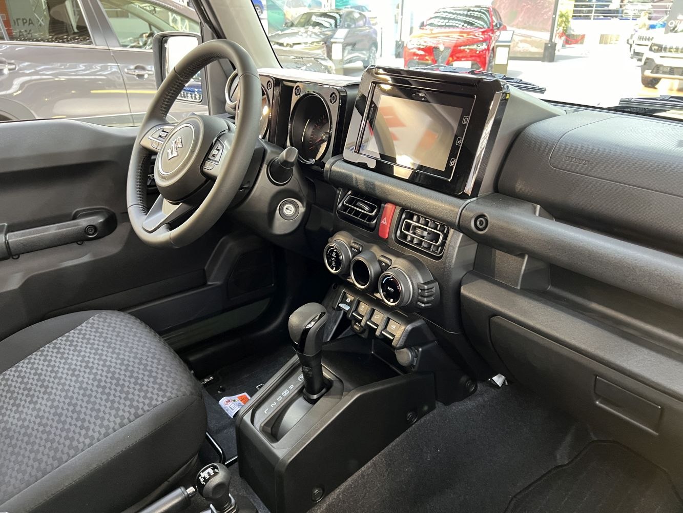 Dashboard, steering wheel, touchscreen, and climate control knobs