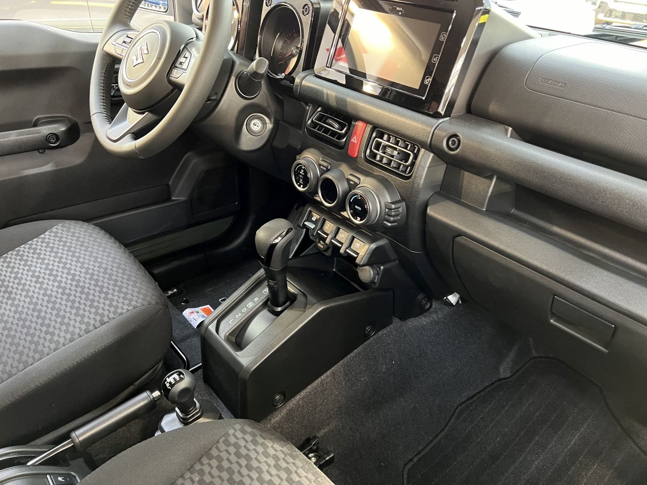 Modern compact SUV interior with touchscreen and manual controls