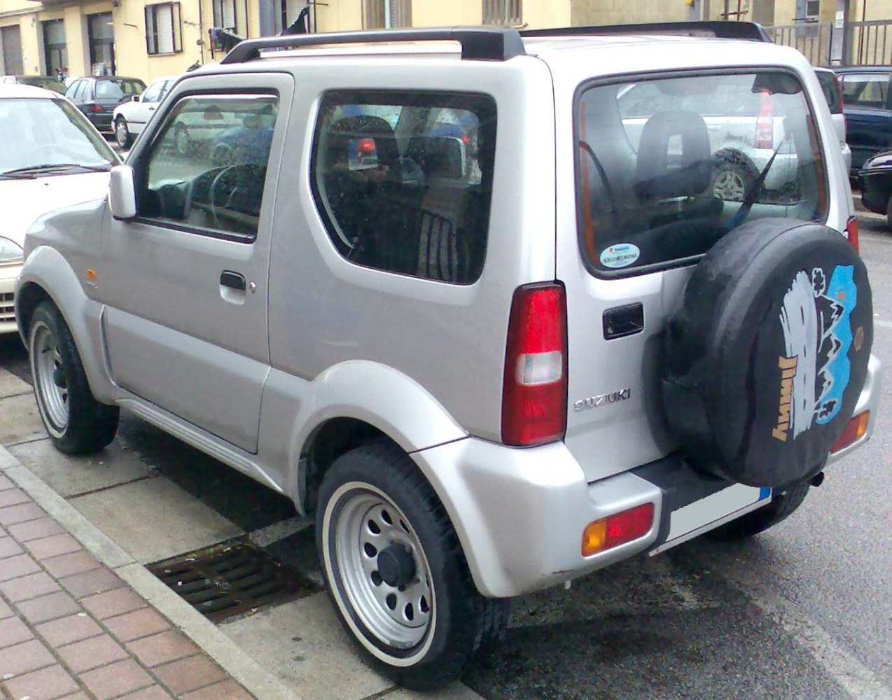 Rear and side profile with spare tire cover on small 4x4 SUV