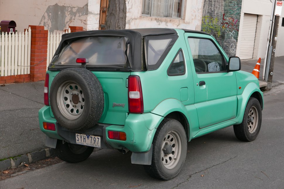 Rear view of compact SUV with soft top and spare tire
