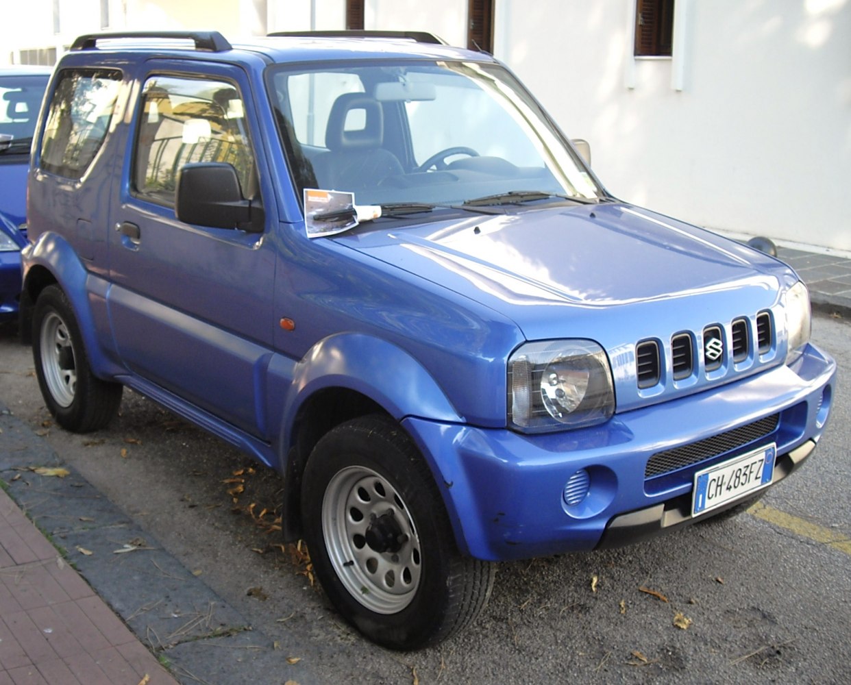 Front side view of blue compact SUV with distinctive grille