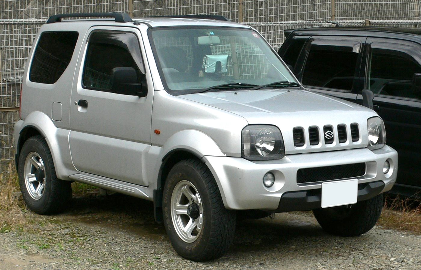 Compact off-road SUV with rounded headlights and vertical grille slots