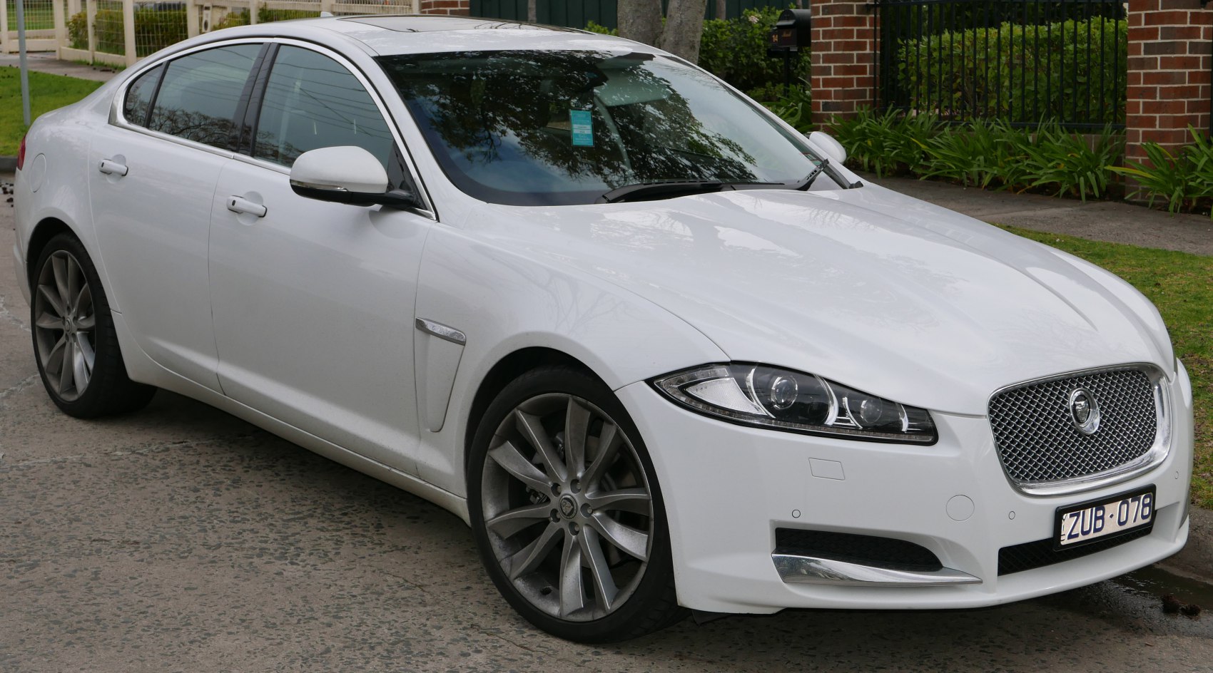 Front 3/4 view with distinctive headlights and alloy wheels