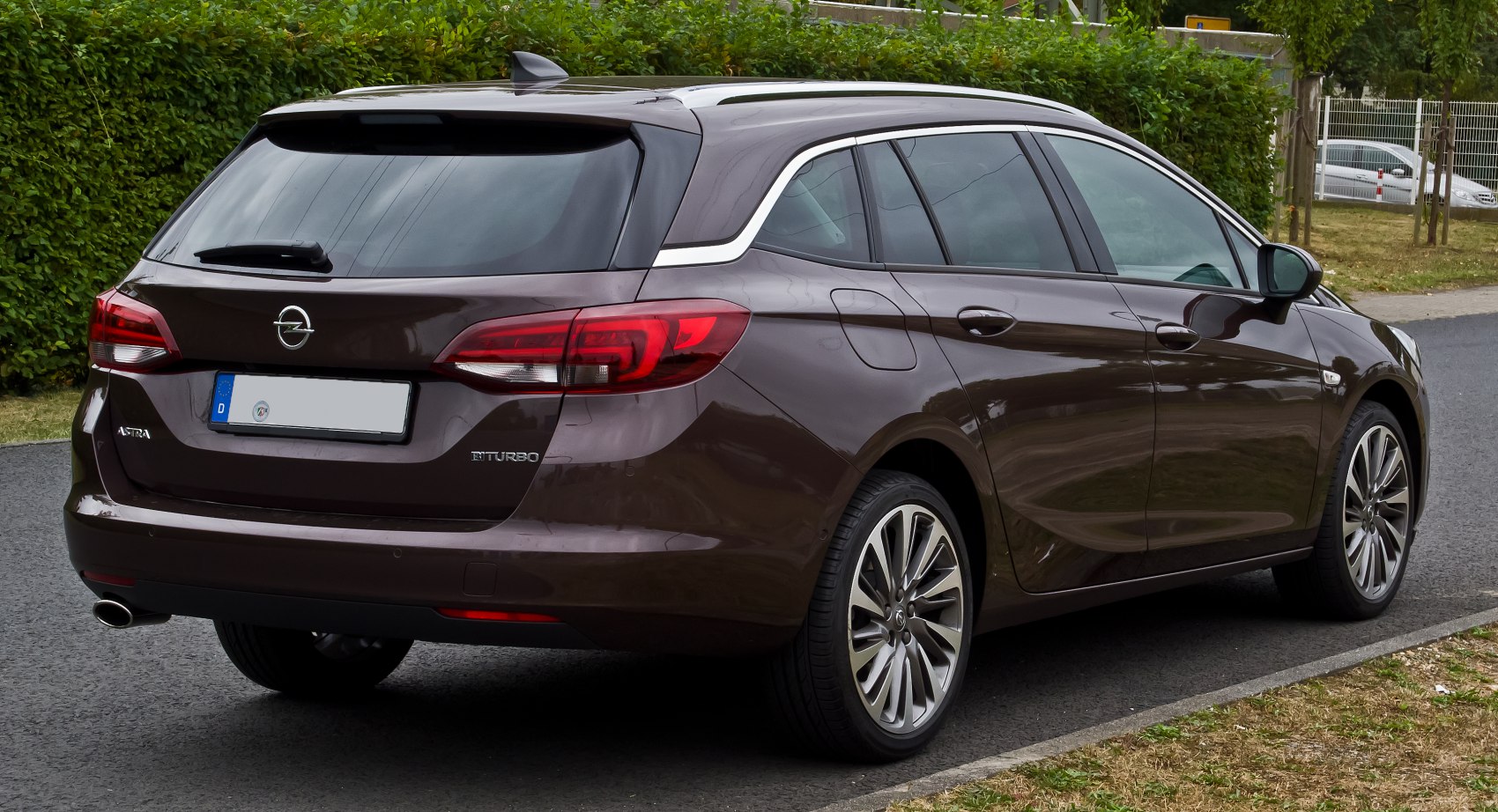 Rear view of sleek station wagon with distinctive tail lights and alloy wheels