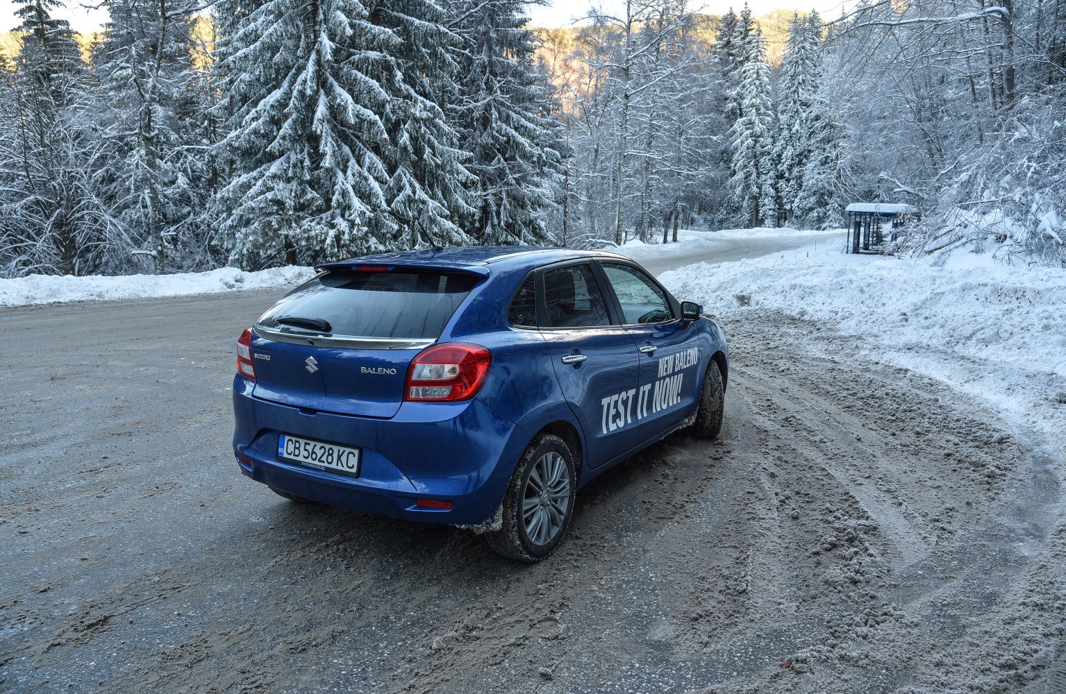 Rear-side hatchback in snowy mountain road