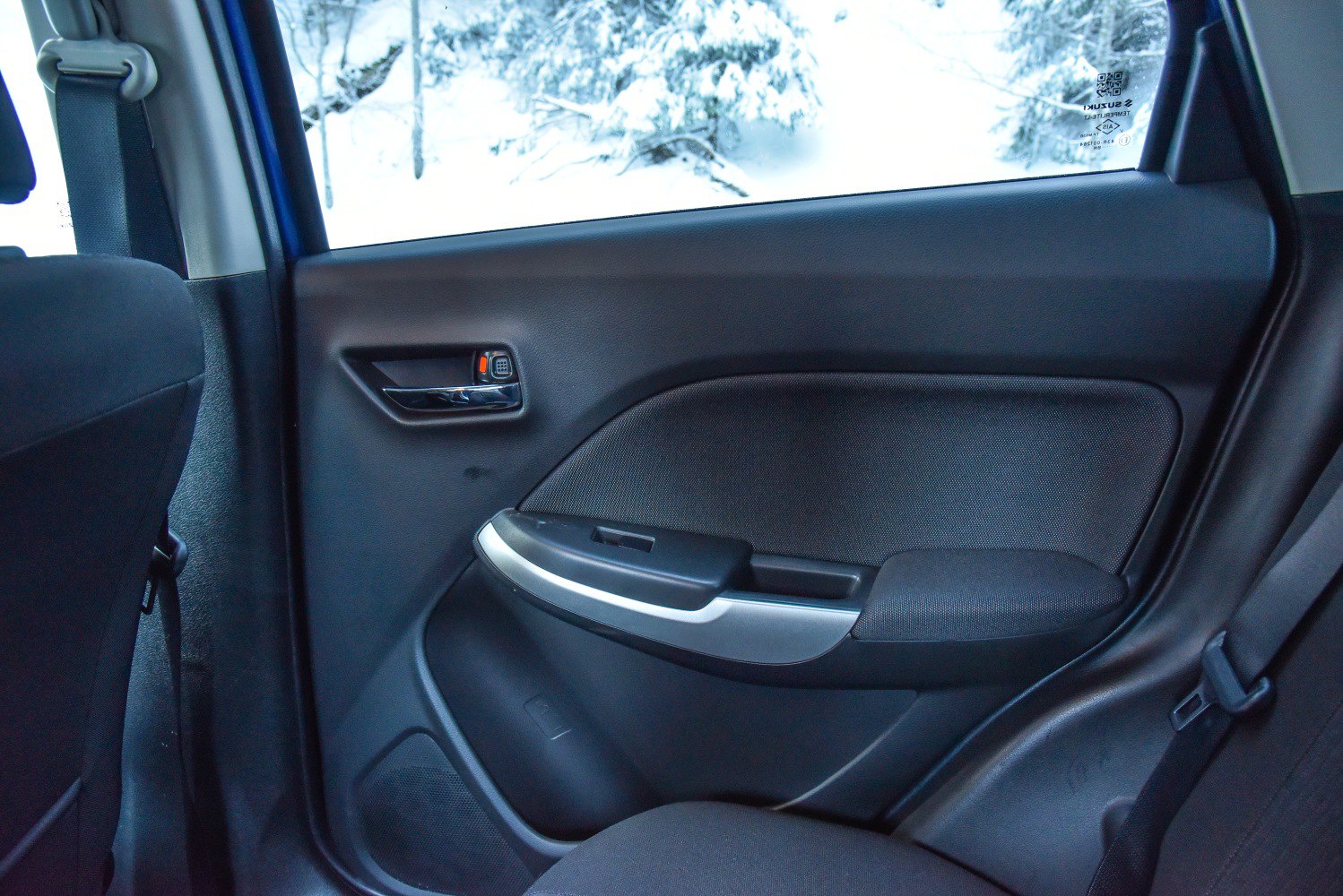 Rear door interior panel with armrest and window control