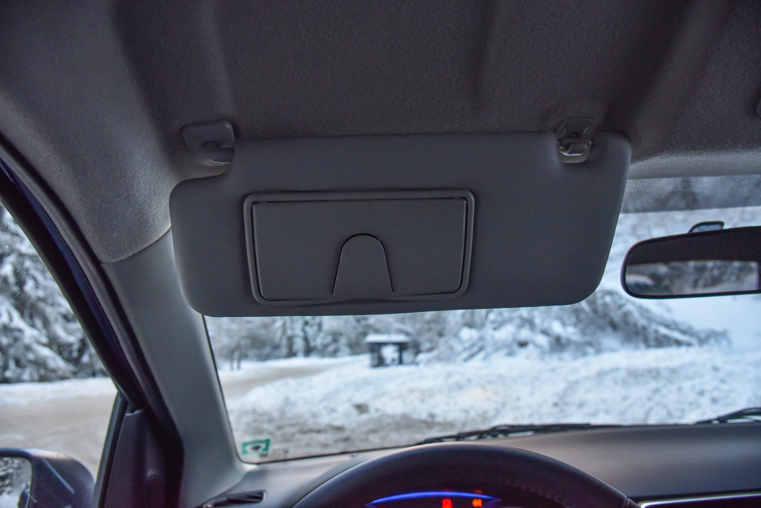 Car interior sun visor and rearview mirror close-up
