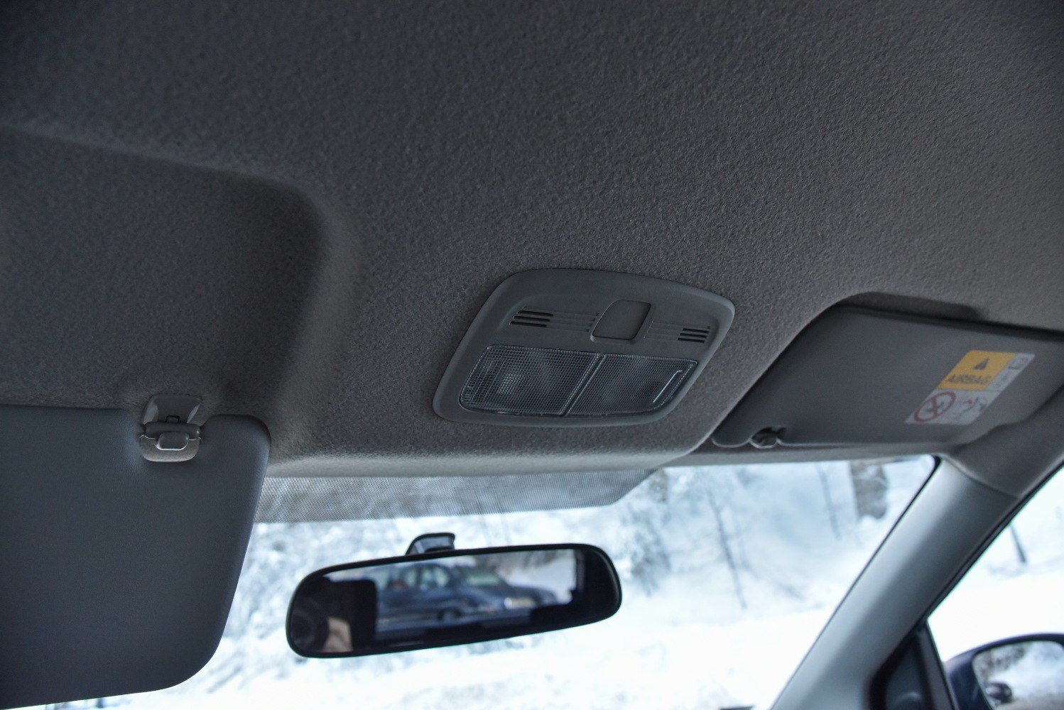 Overhead interior light and rearview mirror with sun visor