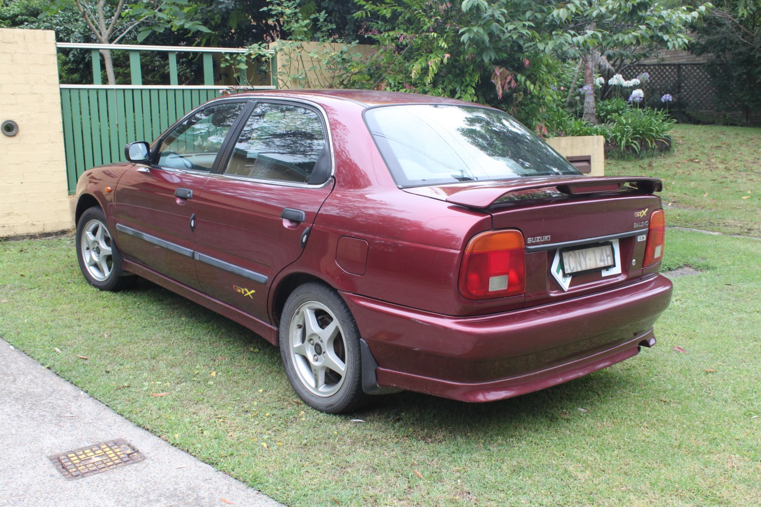 Rear side view of classic sedan with spoiler and alloy wheels