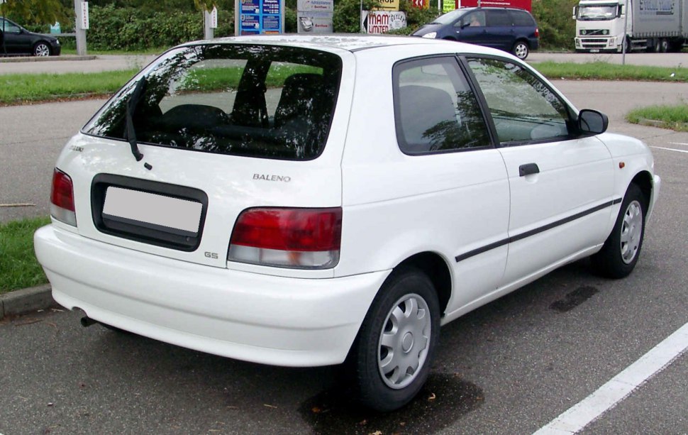 Rear view of a compact white hatchback with rear wiper and taillights.