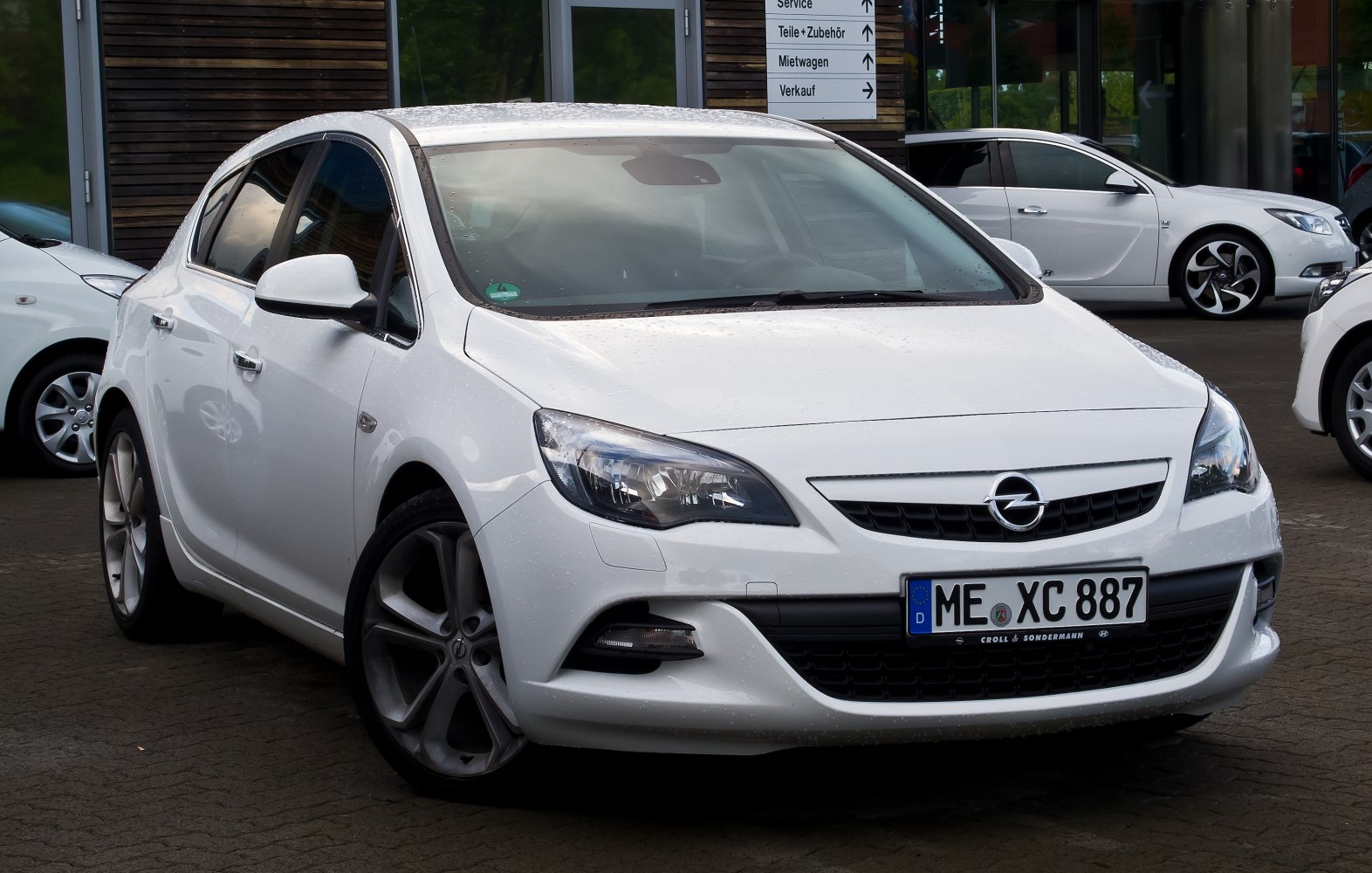White sedan front and side view with alloy wheels and sharp headlights