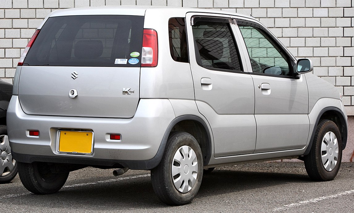 Rear-side view of a compact hatchback with boxy shape and rectangular tail lights.