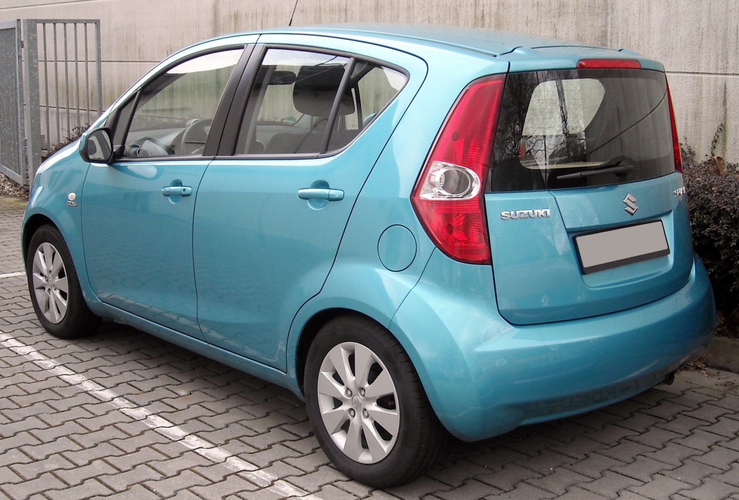 compact hatchback rear view with distinctive tail lights and rear window