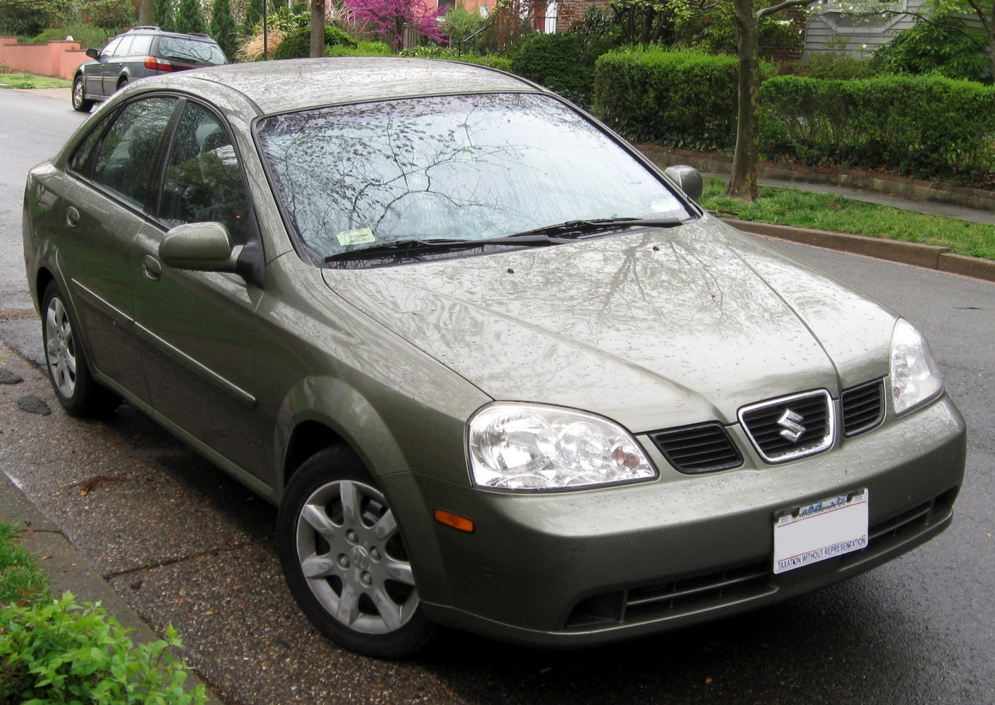 Compact sedan front and side profile with headlights, grille, and alloy wheels