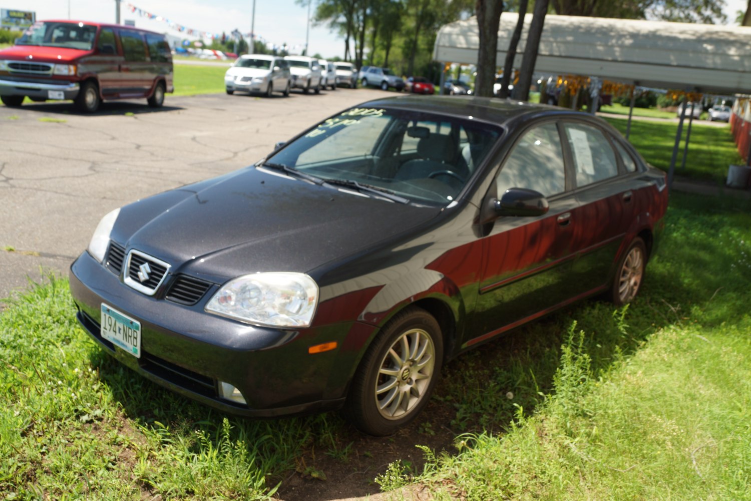 Front side view of a compact sedan with distinctive grille and alloy wheels