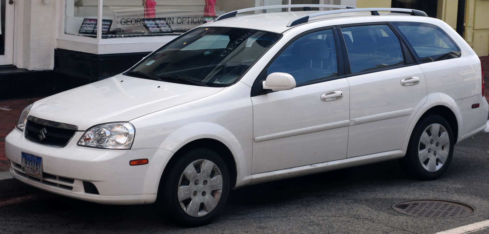 White wagon with roof rails, alloy wheels and multiple windows.