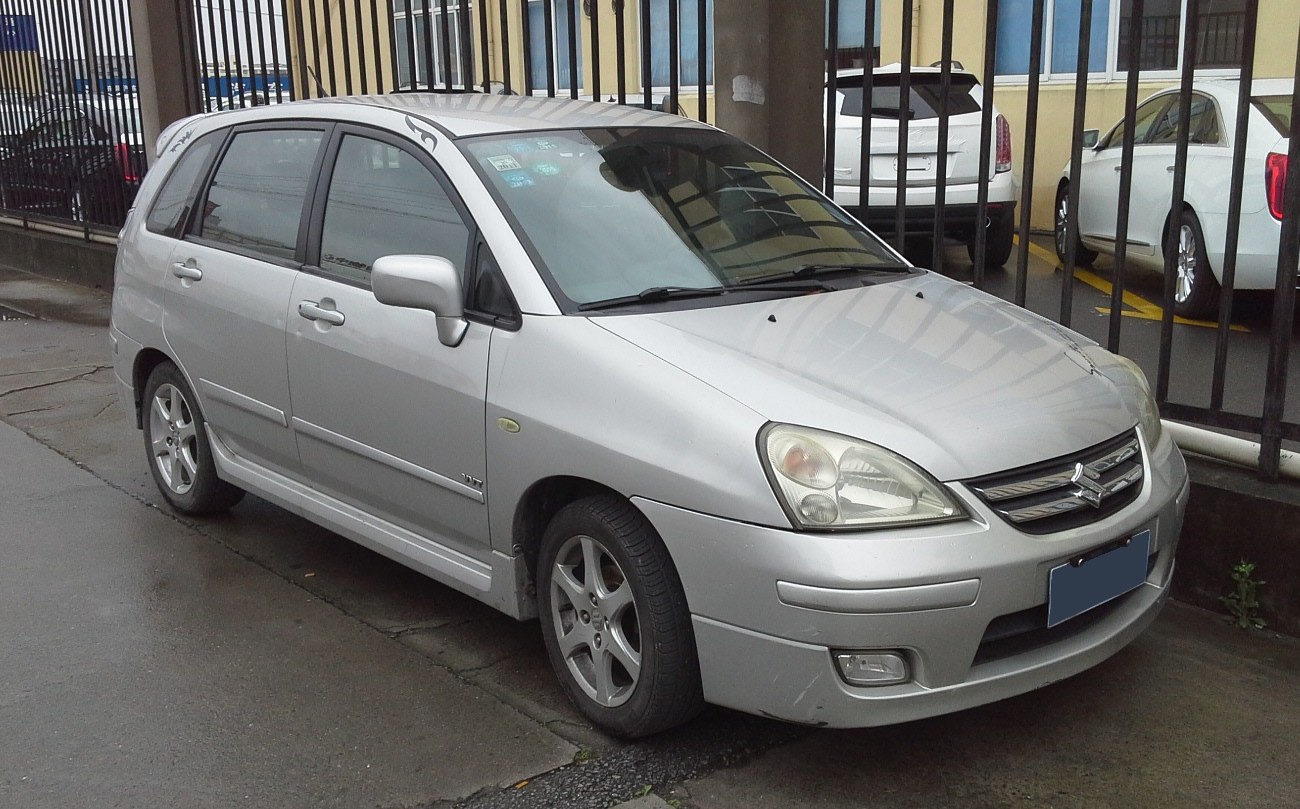 Silver compact wagon front side view with alloy wheels and tinted windows