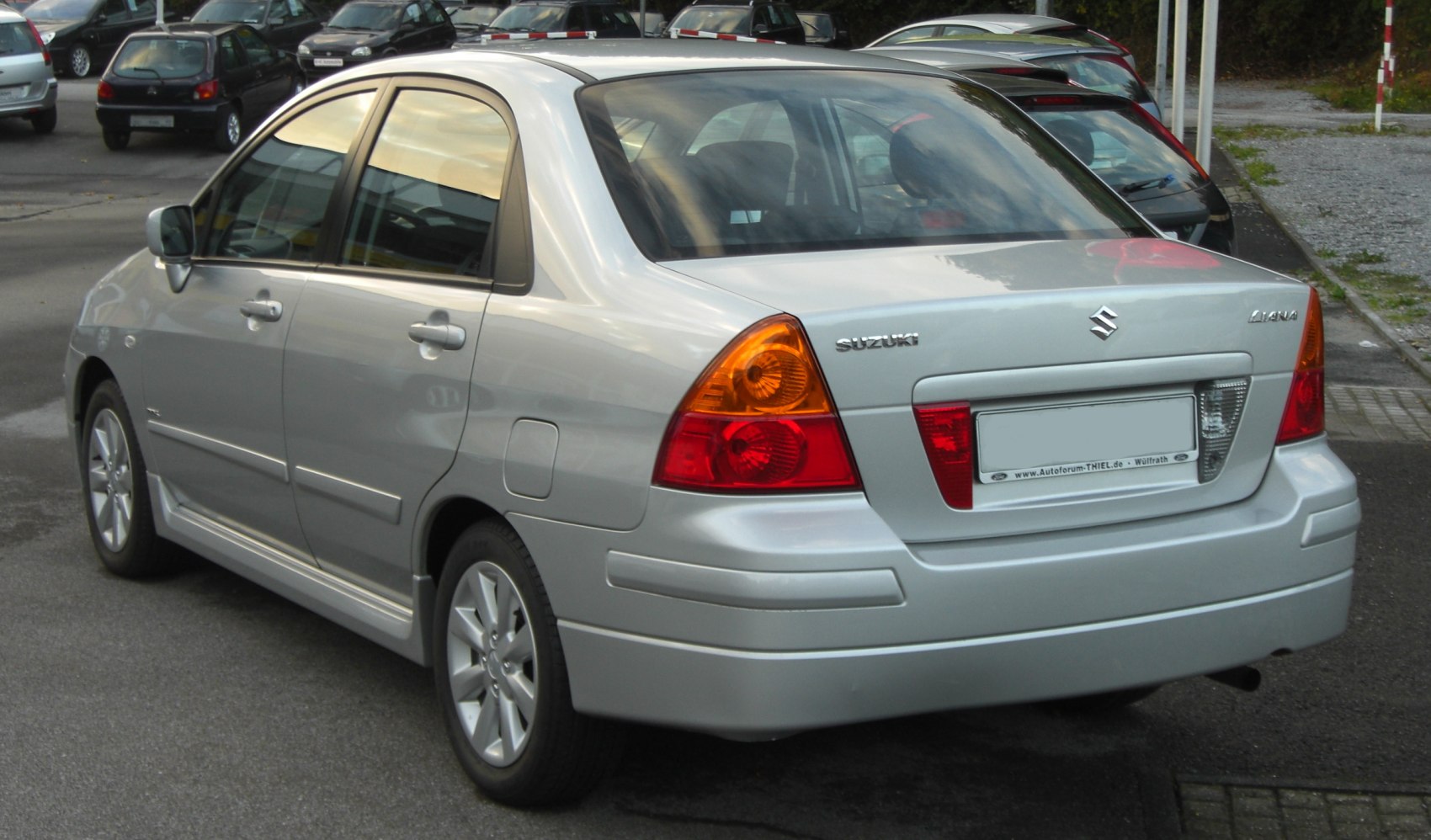 Rear view of a silver sedan highlighting taillights and body contours