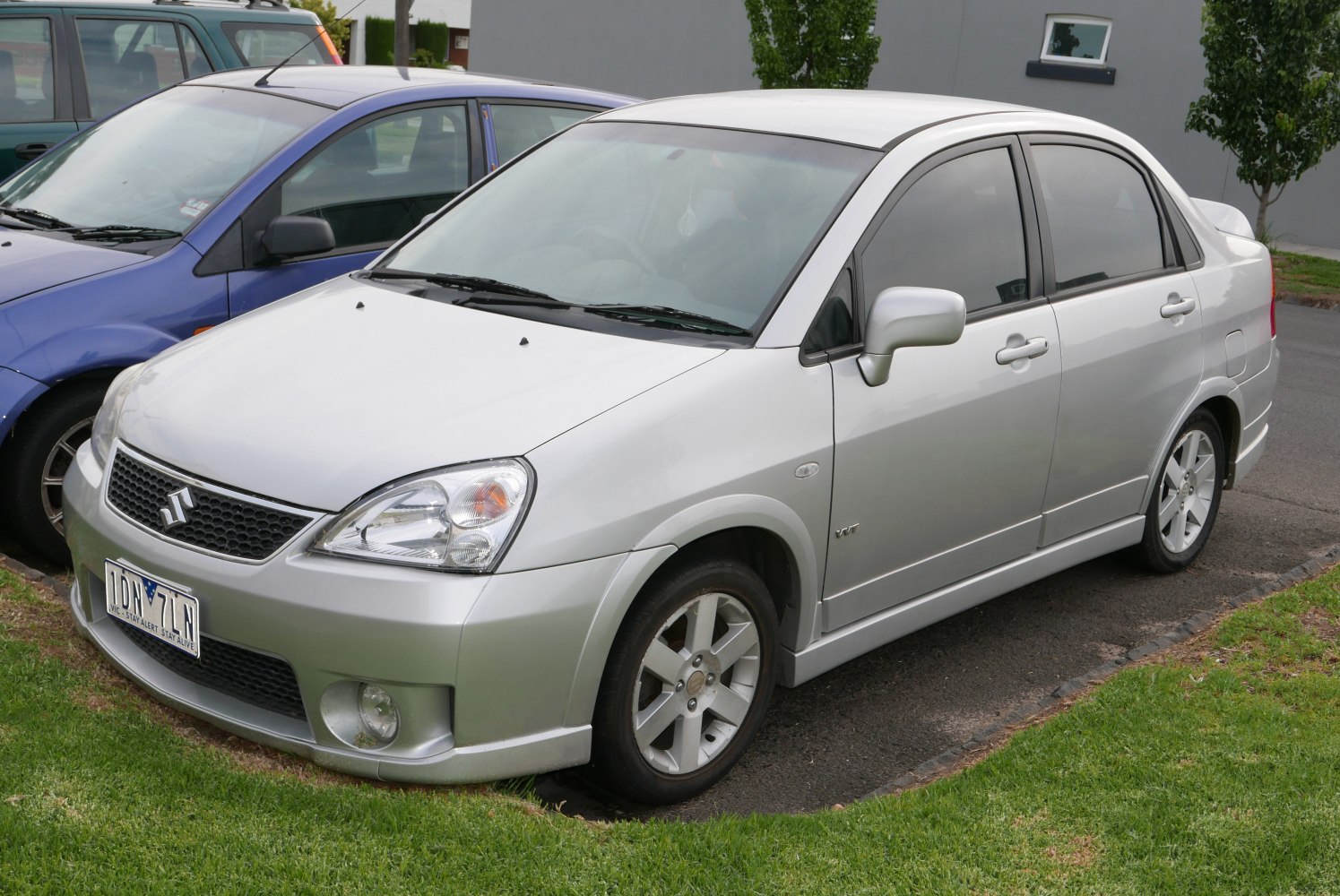 Silver four-door sedan with sporty alloy wheels and tinted windows